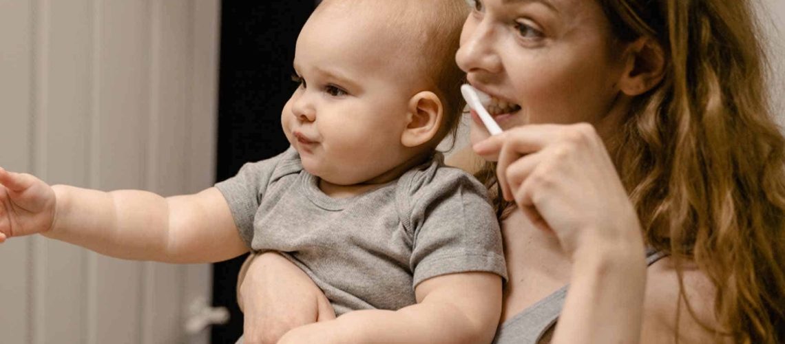 Mother and Young Child Brushing Teeth Together
